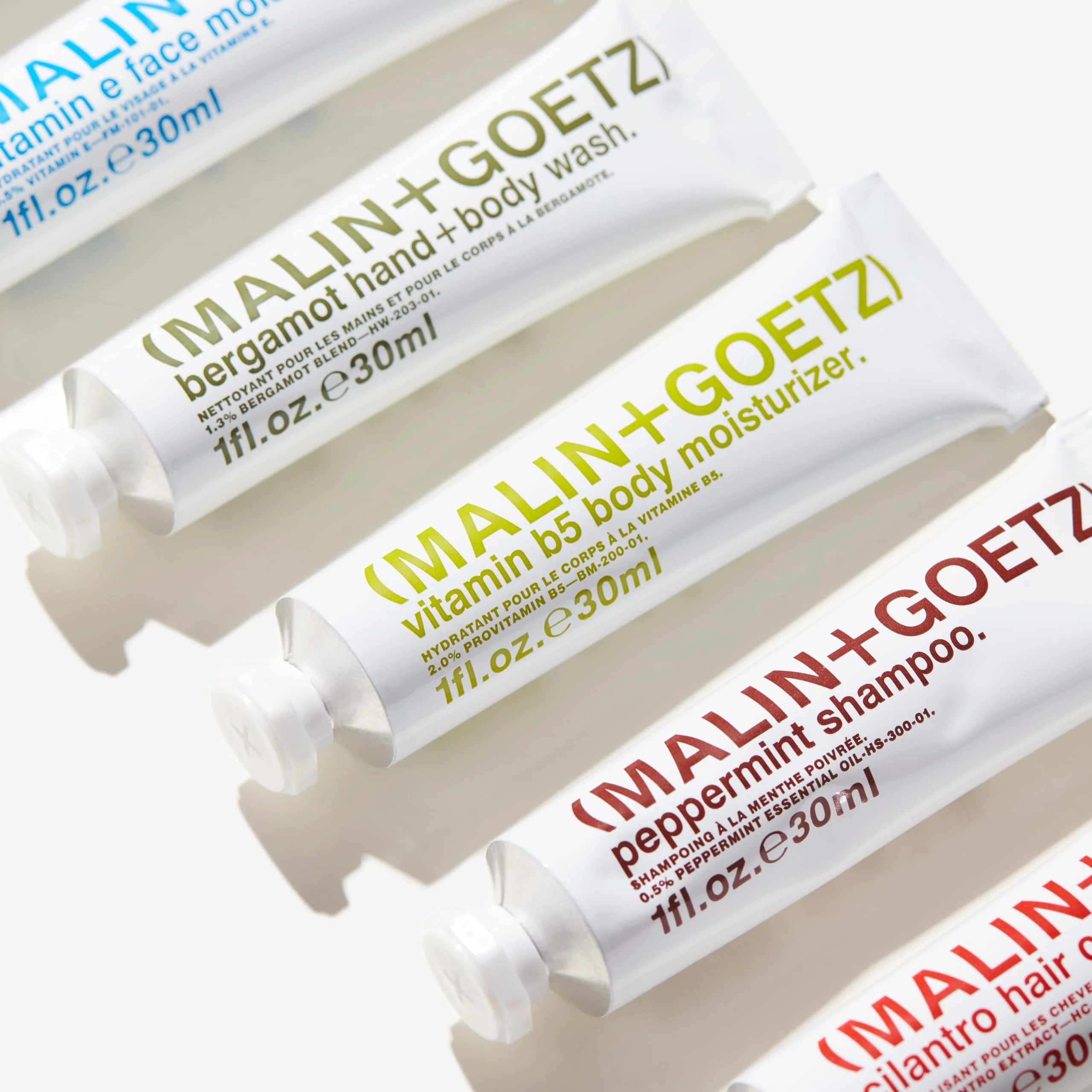 MALIN+GOETZ Best-Sellers Travel Kit | Six Everyday Essentials for Face, Body + Hair | Grapefruit Face Cleanser, Vitamin E Face Moisturizer, Peppermint Shampoo + More | Vegan, Travel-Friendly(6 x 1 oz) - Image 4